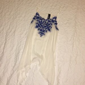 White sleeveless blouse with blue crochet accent